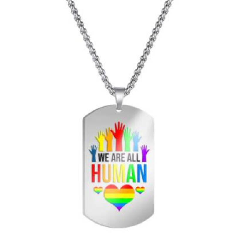 Nøkkelring av metall med teksten "We are all human". Dekorert med vakre pridefarger.